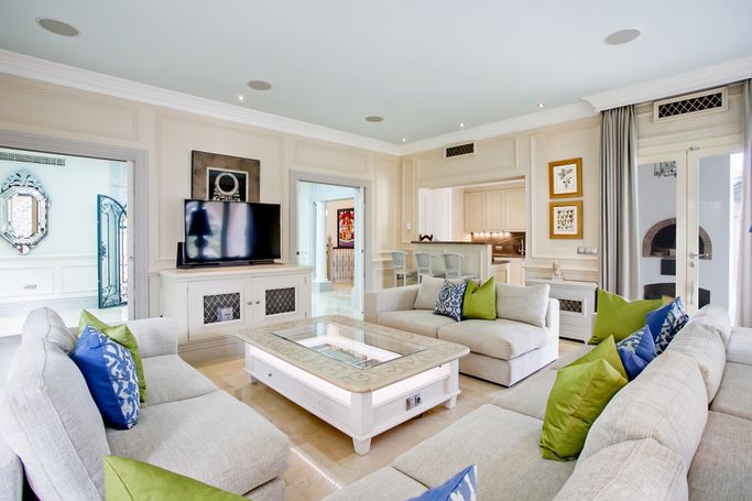 Finished living room and service kitchen with fitted cabinetry in a renovated villa in Andratx, Mallorca.