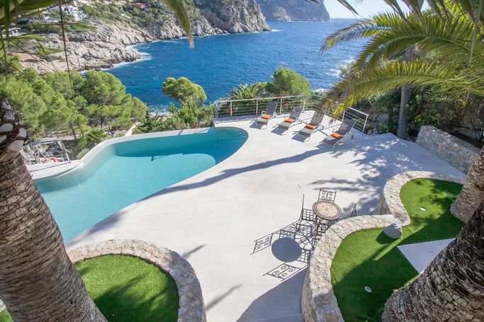 Completed swimming pool and stone terrace overlooking the sea in Andratx, Mallorca.